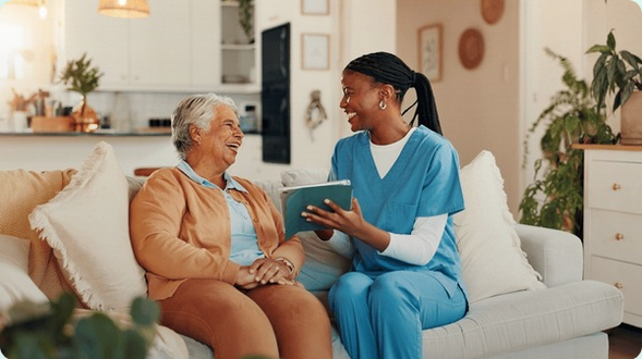 Healthcare professional and patient smiling while reviewing health data on a tablet together